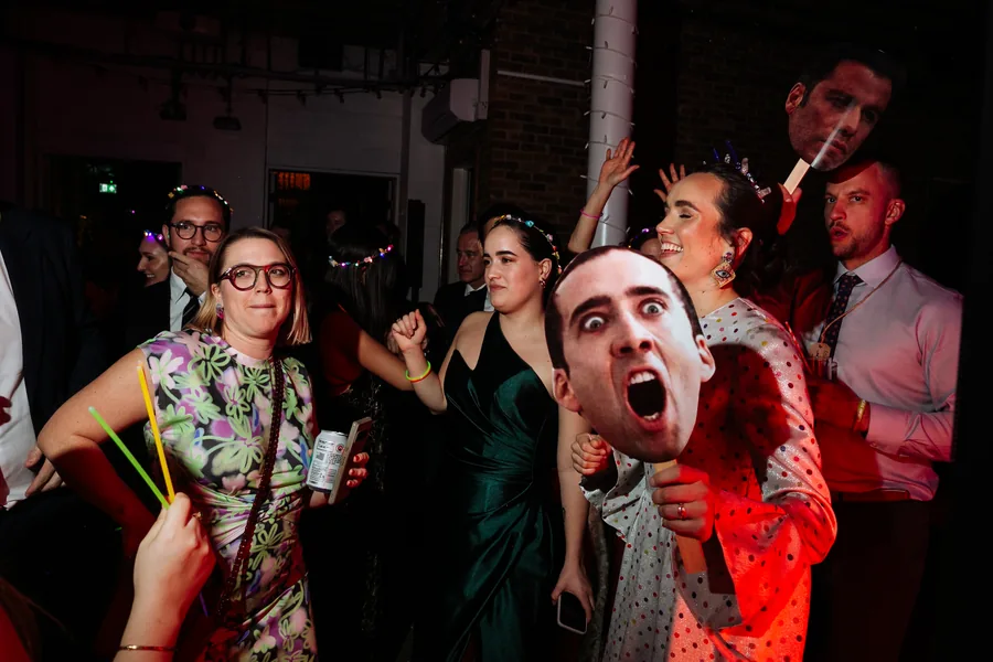 Guests dancing with photo-booth props