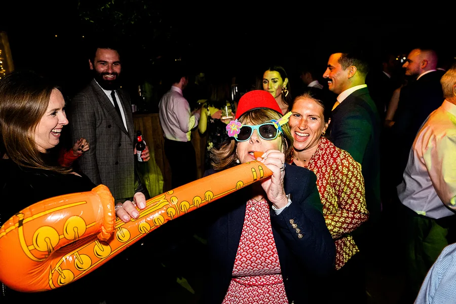 A guest playing an inflatable saxophone
